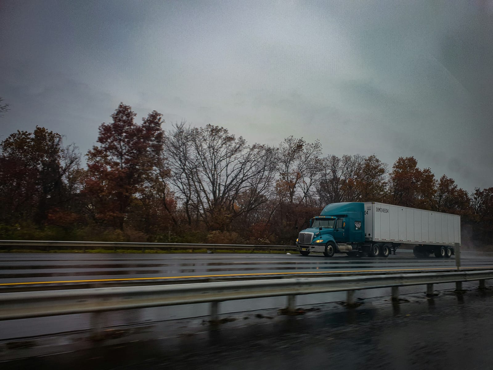 Semi-truck on a wet autumn highway