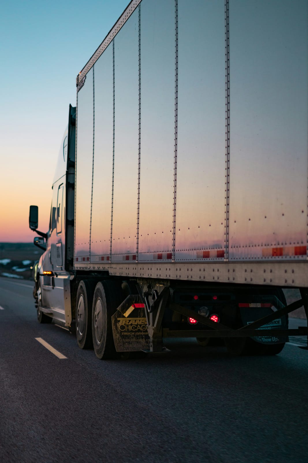 Semi-truck on the highway at dusk