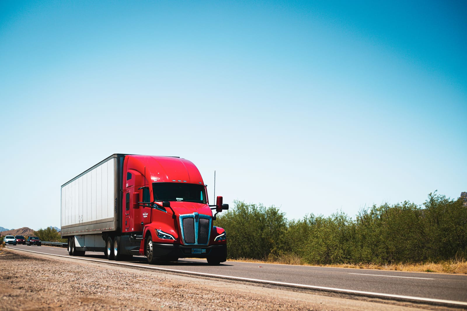 Red semi-truck on a US desert highway