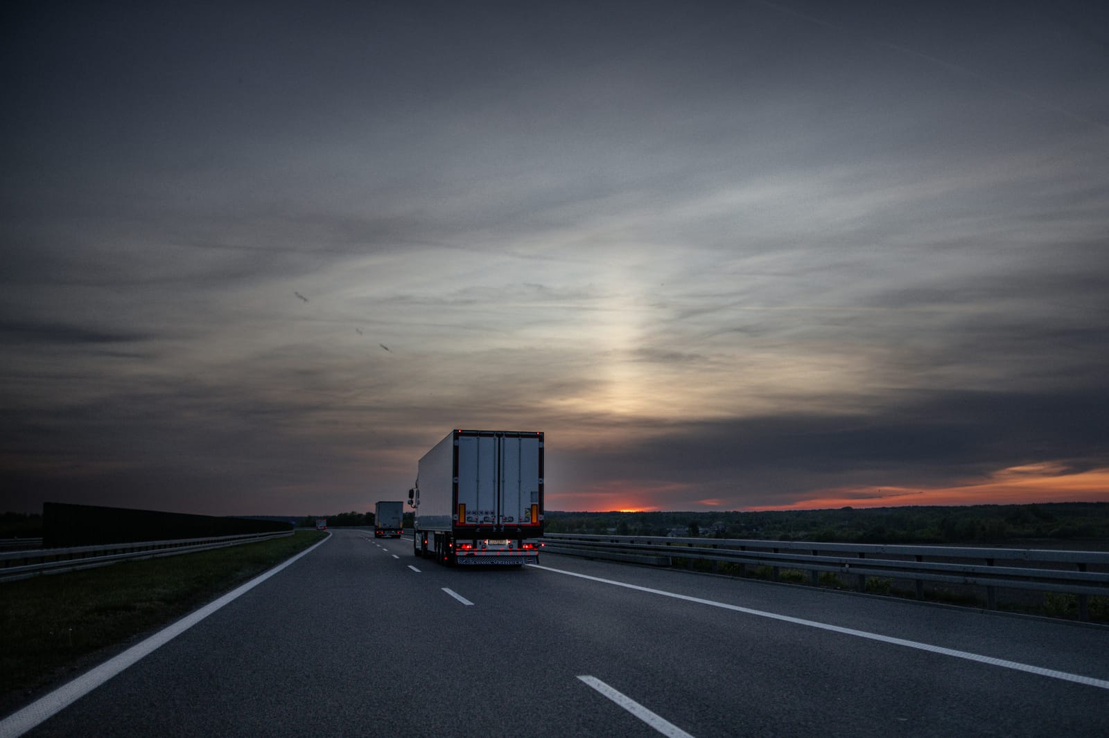 Semi-truck on a highway at sunset