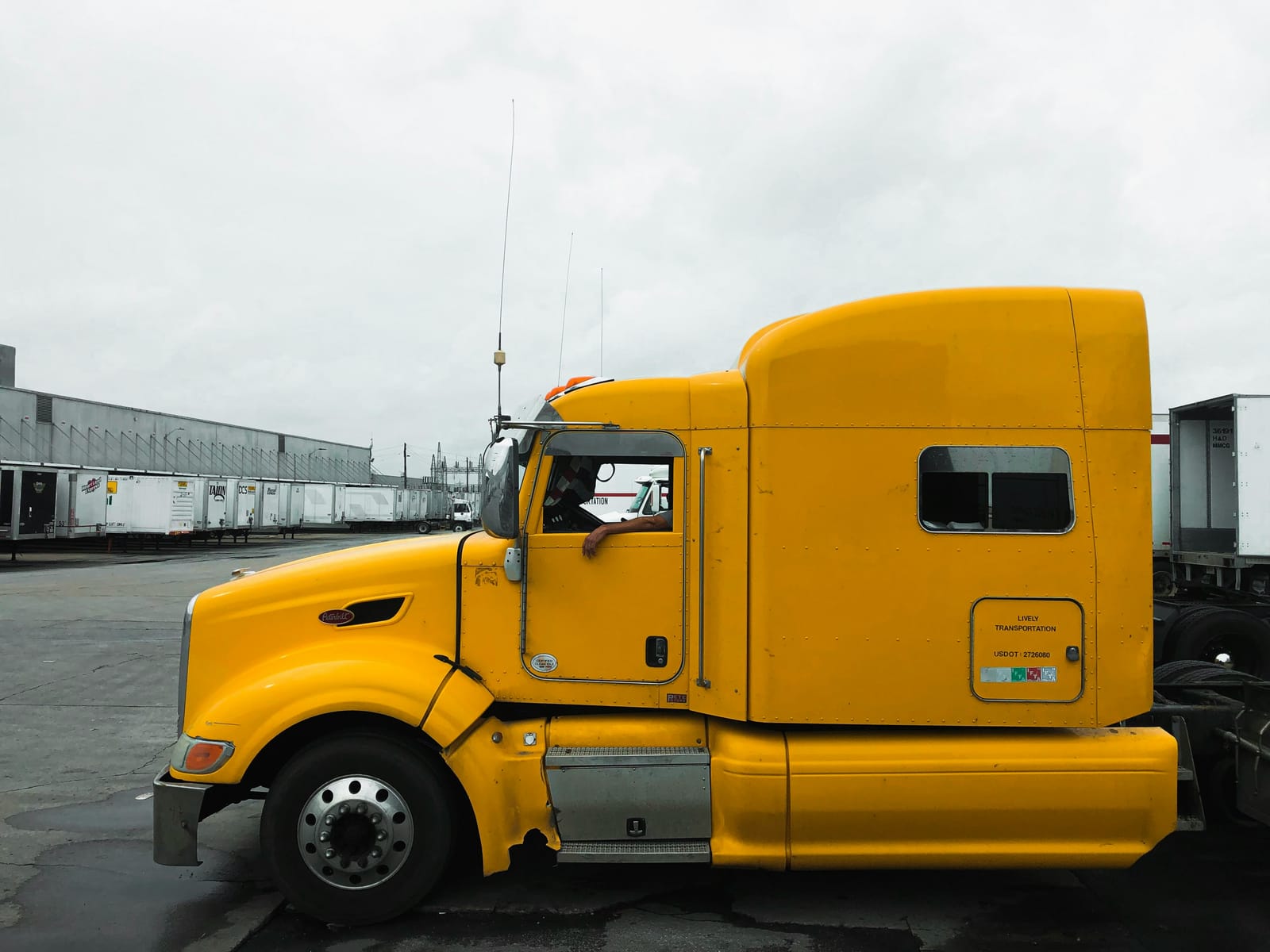 Yellow semi-truck at a freight terminal